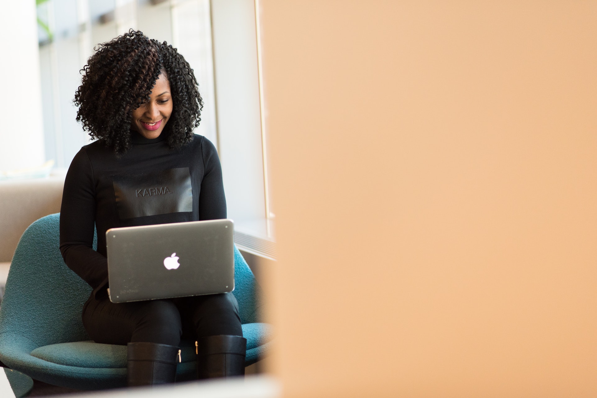 Woman Typing on her Laptop Computer Resume Trips and Tricks The Ashe Academy